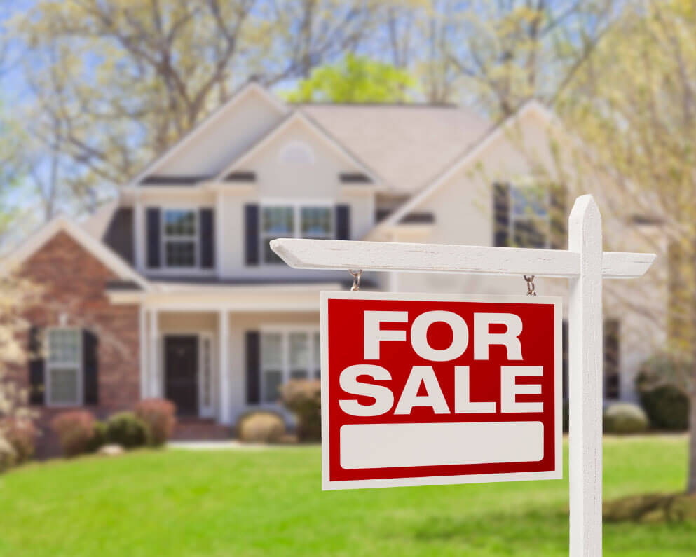 two story home with for sale sign in front yard