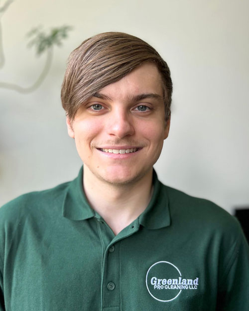 Young man in green Greenland Pro Cleaning polo shirt