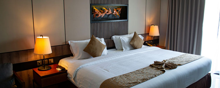 a neatly made bed inside of a hotel room